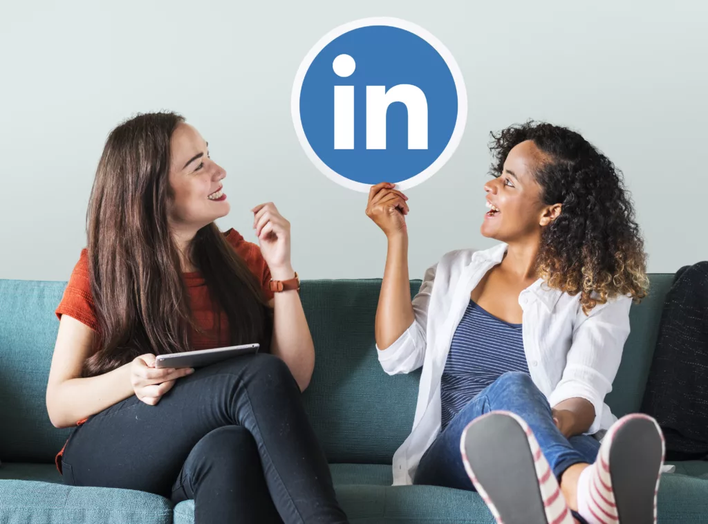Woman holding LinkedIn logo on a couch